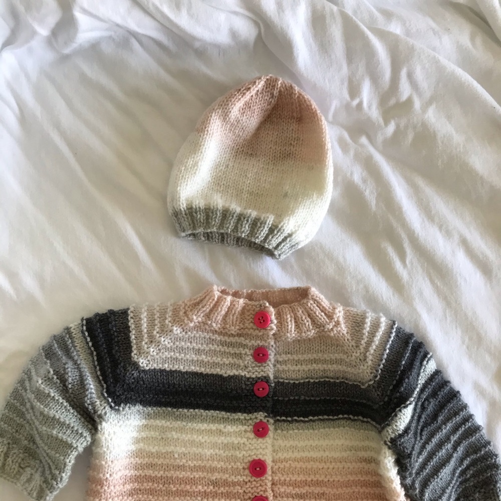 Hand knitted cardigan and matching hat.